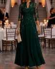 Champagnekleurige maxi-jurk van chiffon en mesh met gouden pailletten, bloemenprint en 3/4-mouwen
