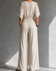 Feline | Elegante beige overslag jumpsuit