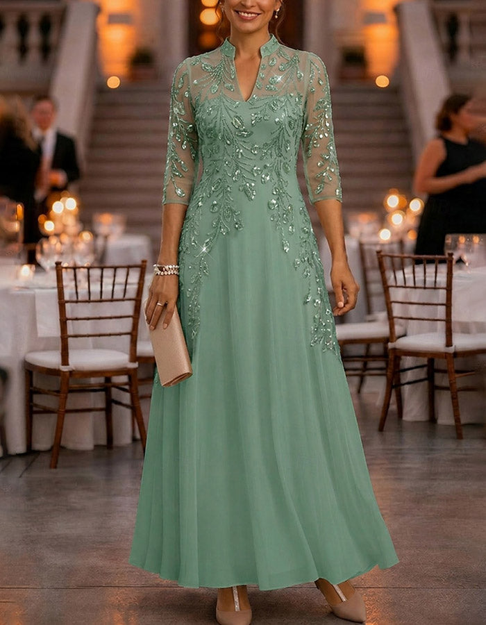 Champagnekleurige maxi-jurk van chiffon en mesh met gouden pailletten, bloemenprint en 3/4-mouwen