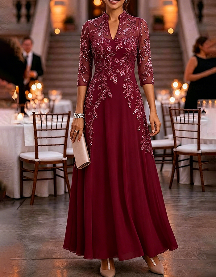 Champagnekleurige maxi-jurk van chiffon en mesh met gouden pailletten, bloemenprint en 3/4-mouwen