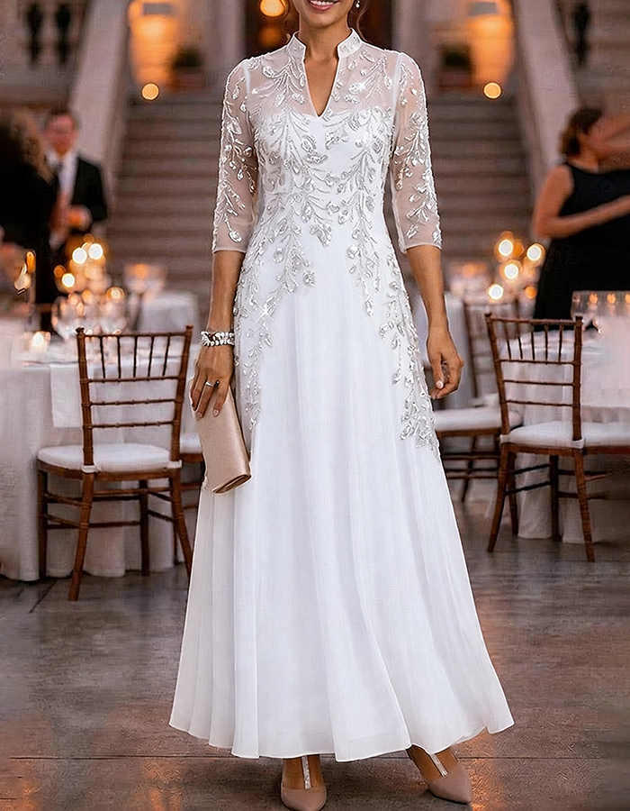 Champagnekleurige maxi-jurk van chiffon en mesh met gouden pailletten, bloemenprint en 3/4-mouwen